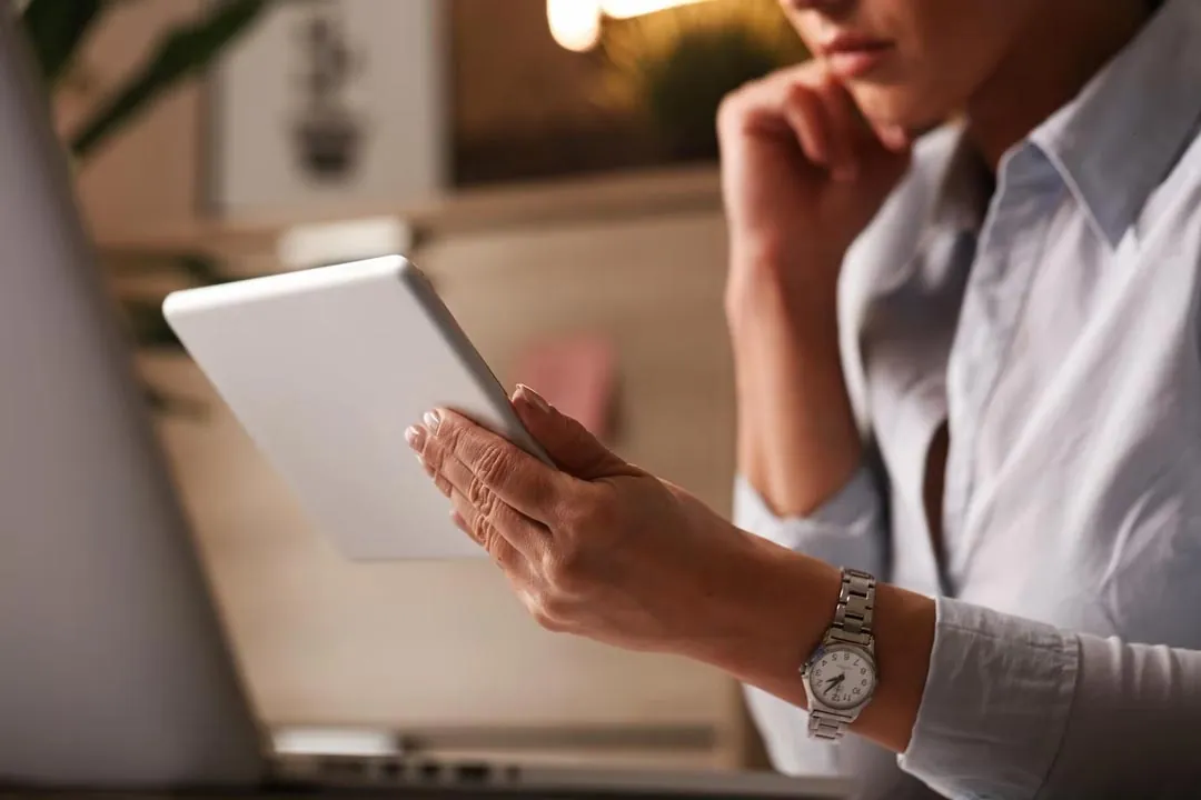A woman reading some information on a tablet