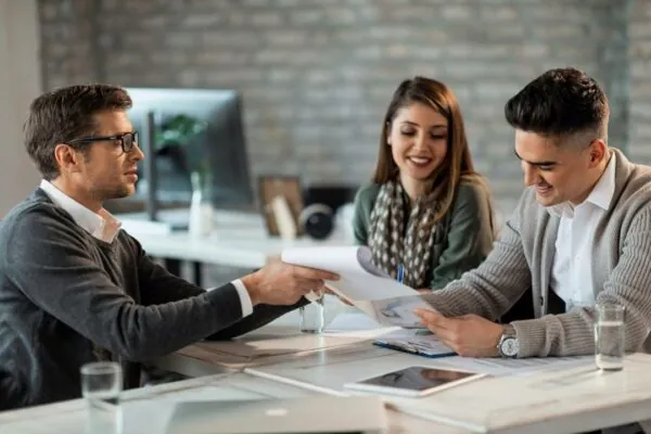 happy couple-signing-contract-meeting-with-their-accounting-office
