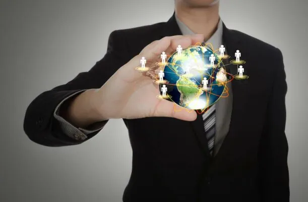 Business man holding the small world in his hands against white