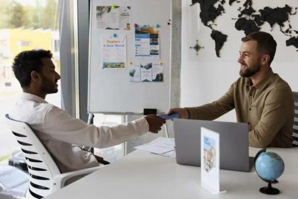 Two men shaking hands inside the office.