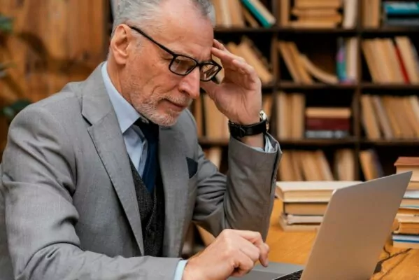 middle-aged-entrepreneur-reading-on-notbook